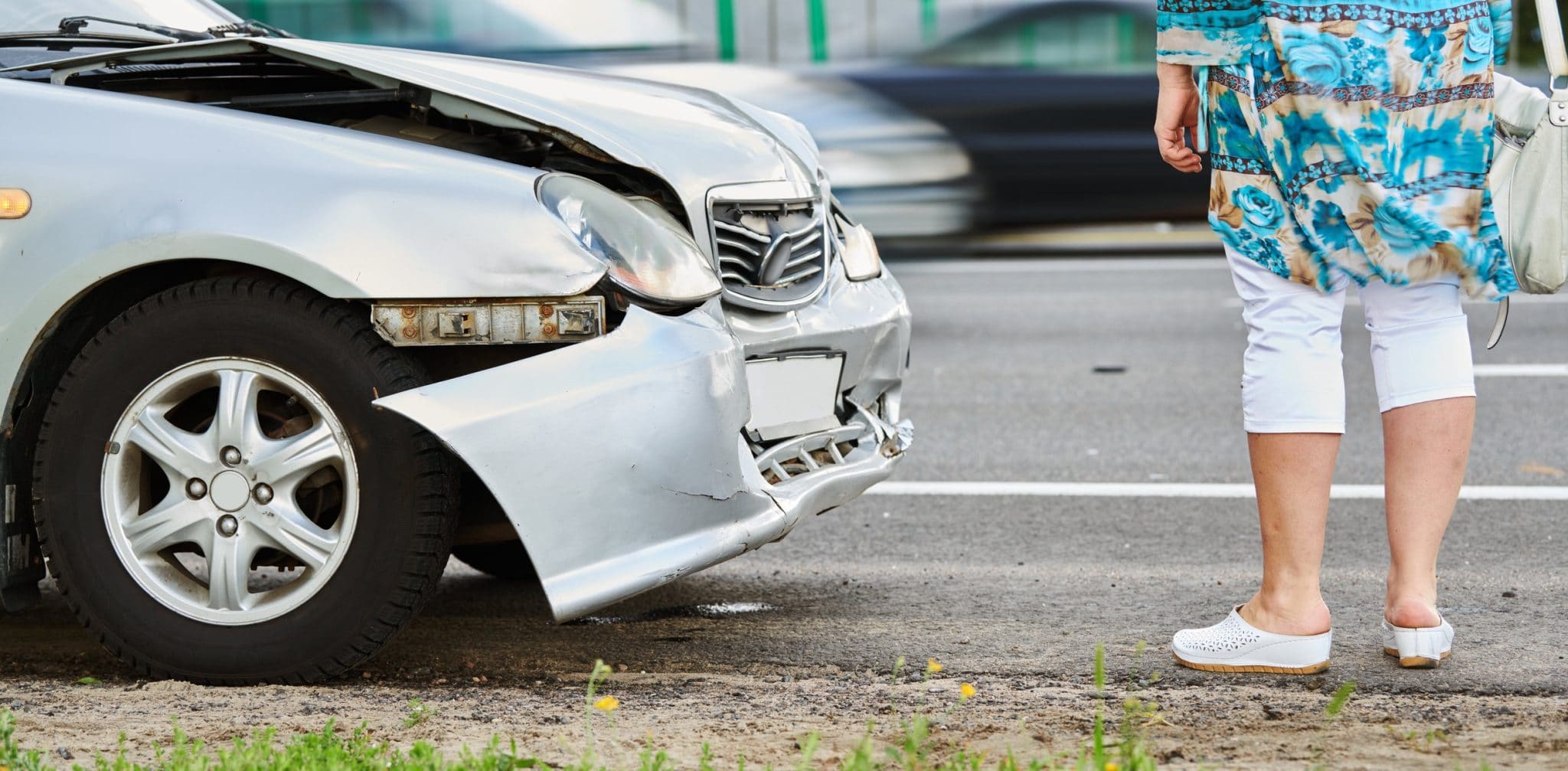 Woman standing outside of her car after a wreck