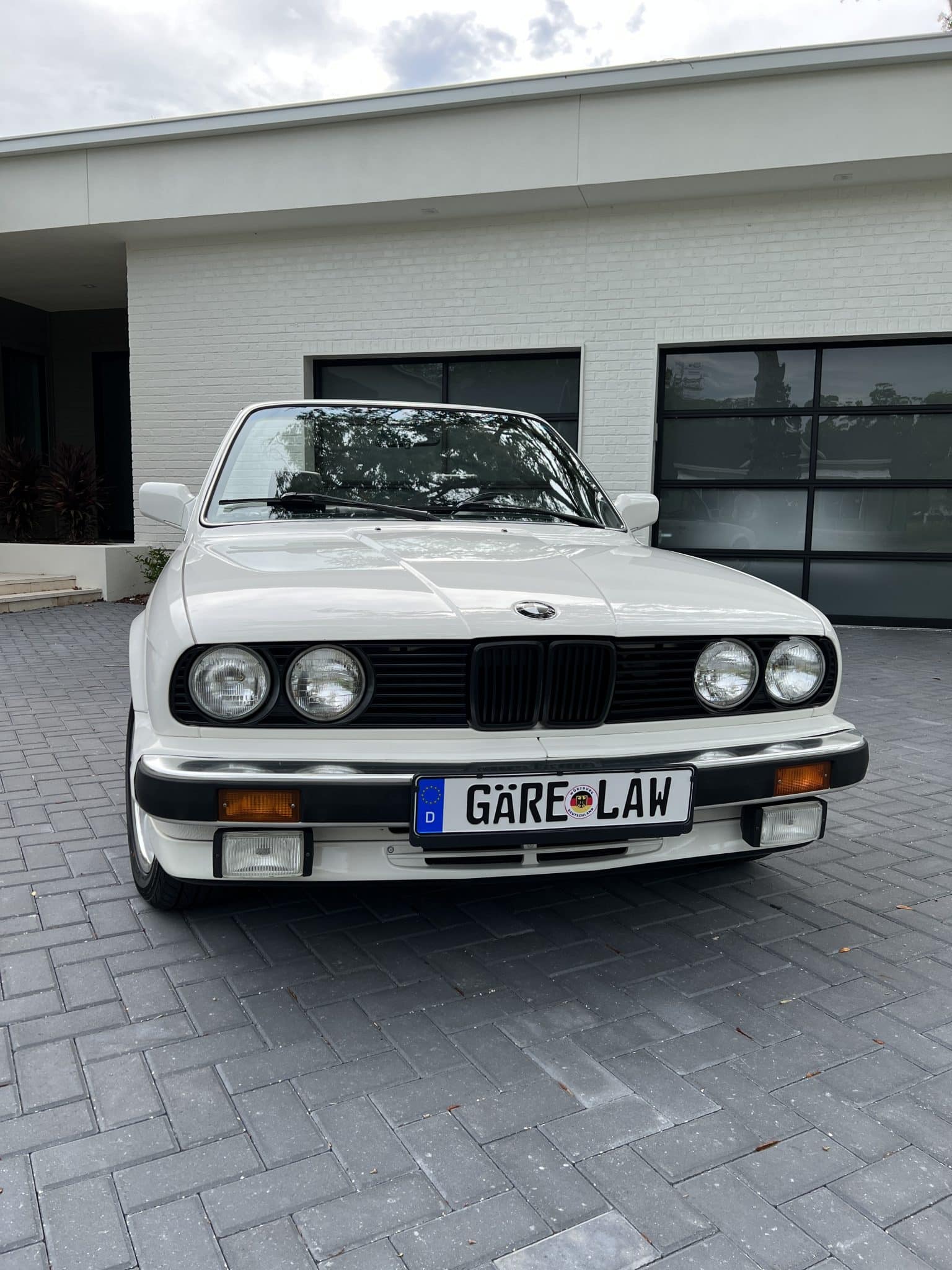 Henry Gare's BMW white car with license plate reading Gare Law