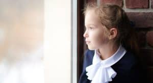 Young girl looking out a window