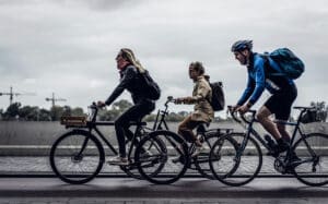 Three bicyclists riding down a public street